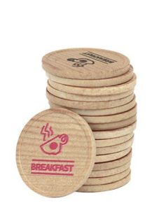 Träpolletter staplade på varandra. Rött och svart tryck på polletterna